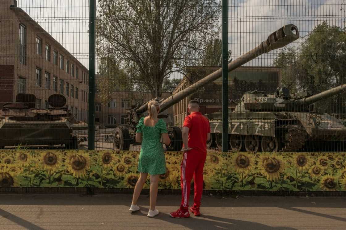 Residents look at destroyed Russian armored military vehicles in Kryvyi Rig, the Ukrainian leader's hometown regularly shelled by Russian forces Residents look at destroyed Russian armored military vehicles in Kryvyi Rig, the Ukrainian leader's hometown regularly shelled by Russian forces