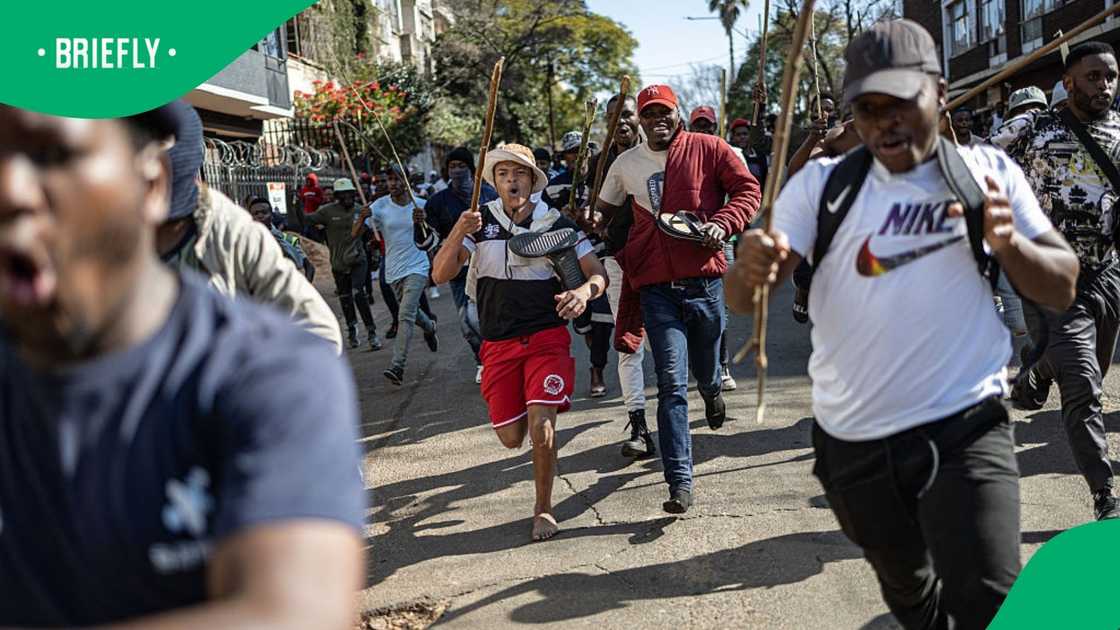Protesters run away during an anti-illegal immigration march in Johannesburg Protesters run away during an anti-illegal immigration march in Johannesburg