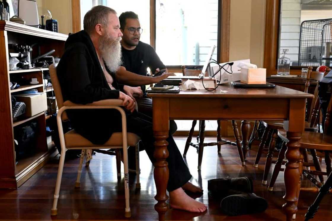 Rodney Gorham, who has a  Synchron brain implant, works on a computer at his home in Melbourne with clinical field engineer Zafar Faraz Rodney Gorham, who has a  Synchron brain implant, works on a computer at his home in Melbourne with clinical field engineer Zafar Faraz