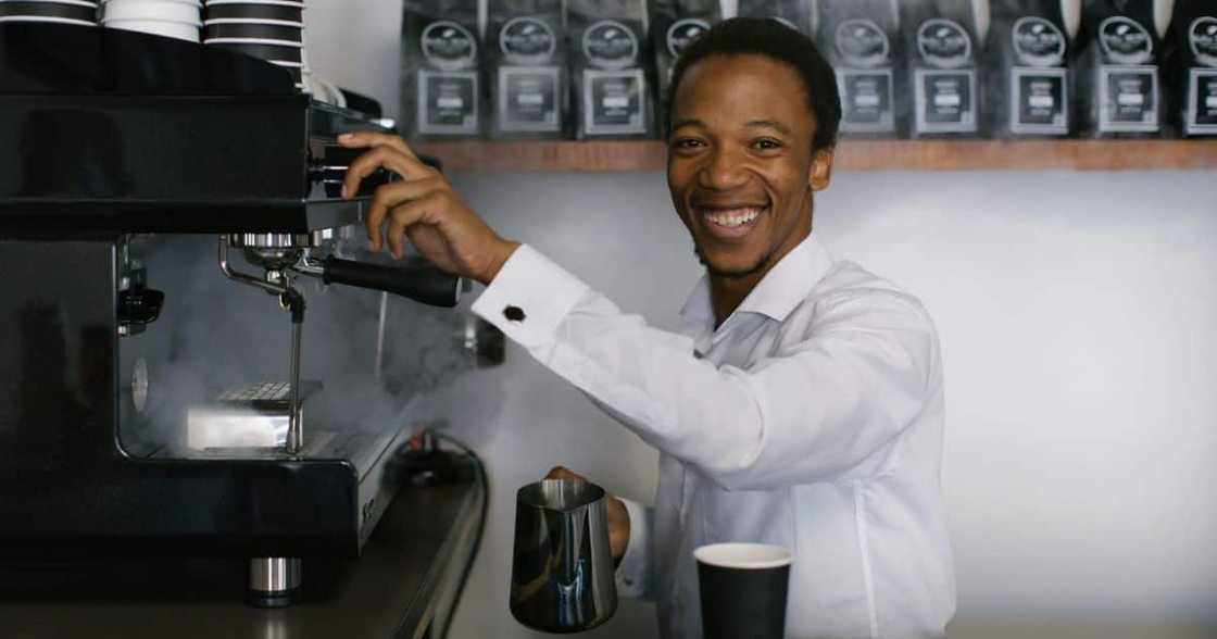 Mhlengi Ngcobo working a coffee machine at his shop Mhlengi Ngcobo working a coffee machine at his shop