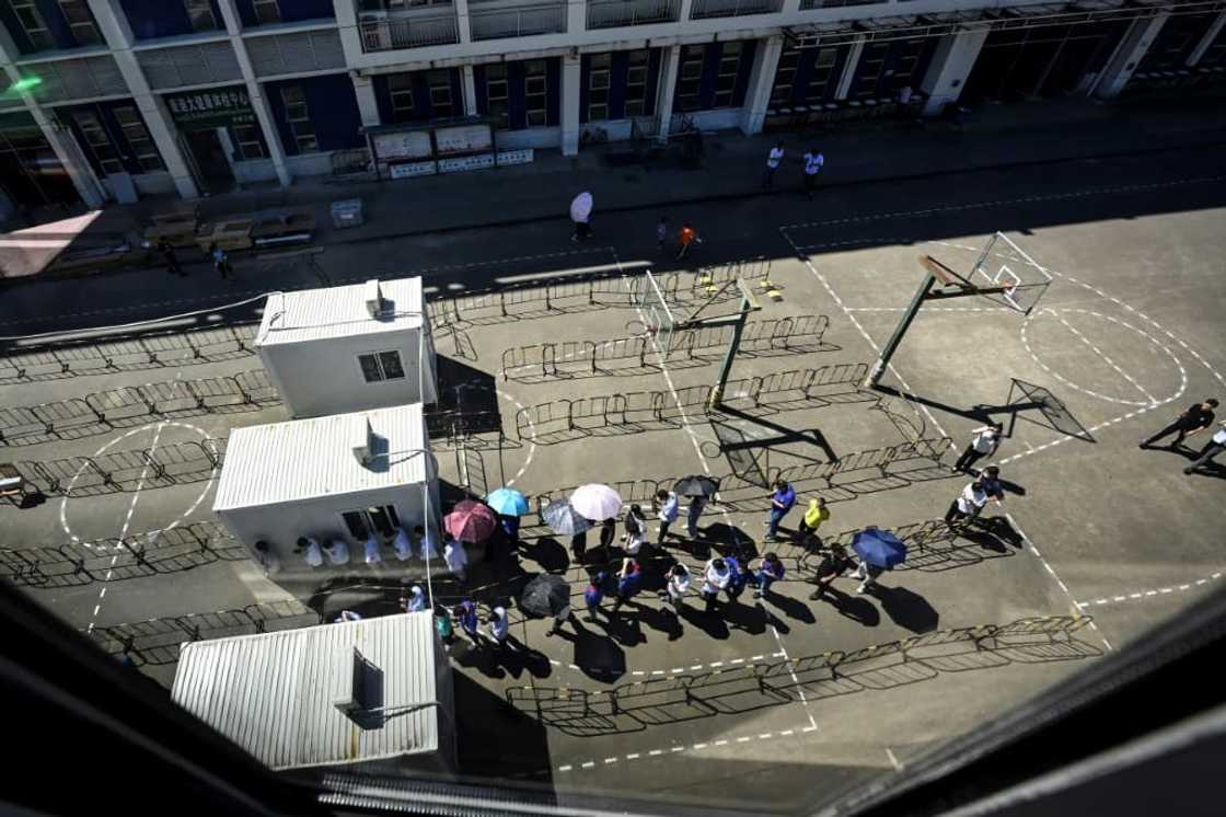 Employees of electric carmaker BYD line up for Covid-19 tests in Shenzhen, where authorities are rushing to stamp out an outbreak Employees of electric carmaker BYD line up for Covid-19 tests in Shenzhen, where authorities are rushing to stamp out an outbreak