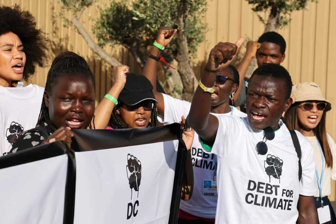 Activists lift banners as they stage a protest during the COP27 climate conference in the Egyptian Red Sea resort of Sharm el-Sheikh Activists lift banners as they stage a protest during the COP27 climate conference in the Egyptian Red Sea resort of Sharm el-Sheikh