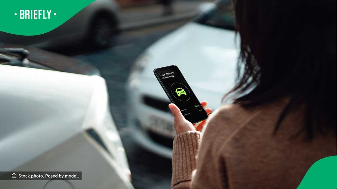 A woman ordering a taxi on a mobile app. A woman ordering a taxi on a mobile app.