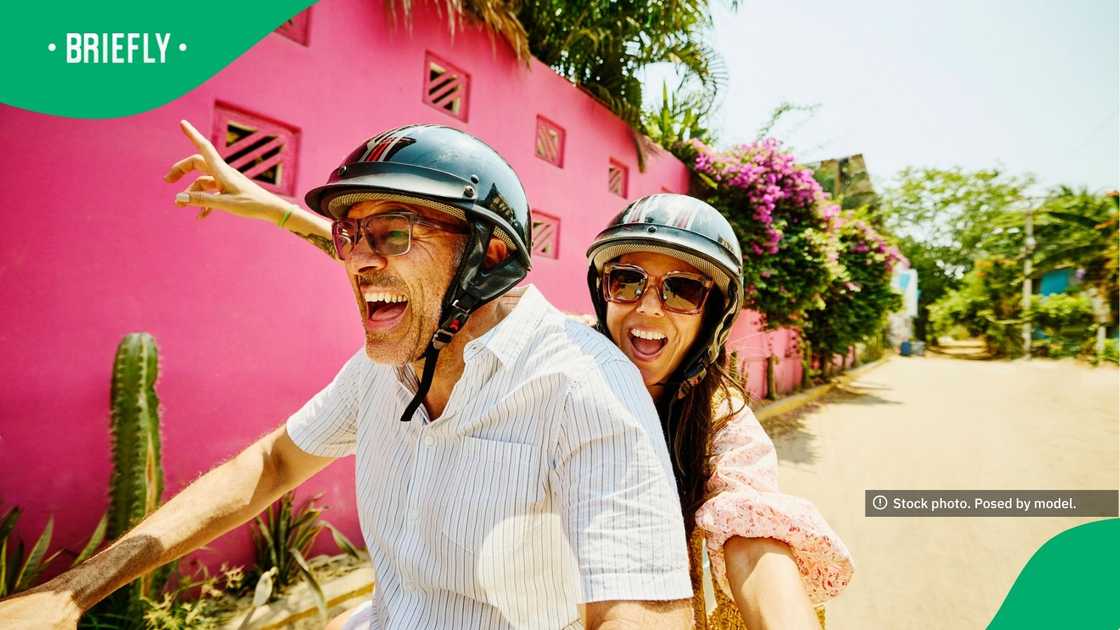 The visual showcased a woman and a man on a scooter, looking happy The visual showcased a woman and a man on a scooter, looking happy