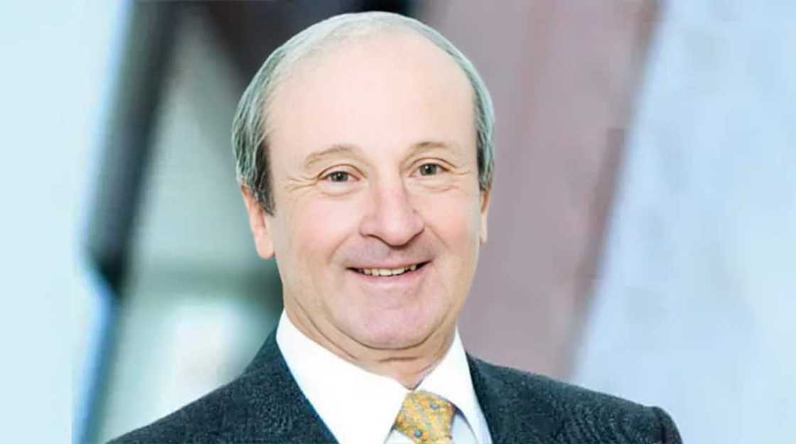 Desmond Sacco smiling in a black suit and a white shirt Desmond Sacco smiling in a black suit and a white shirt