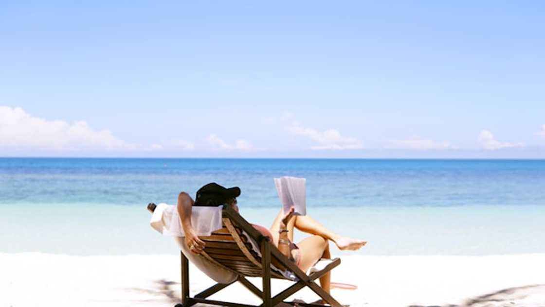 A lady reading while vacationing A lady reading while vacationing