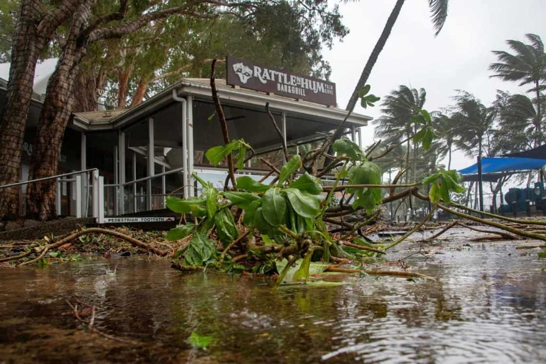 A bar restaurant is seen past fallen branches in Palm Cove as Cyclone Jasper approaches landfall near Cairns in far north Queensland on December 13, 2023. A bar restaurant is seen past fallen branches in Palm Cove as Cyclone Jasper approaches landfall near Cairns in far north Queensland on December 13, 2023.
