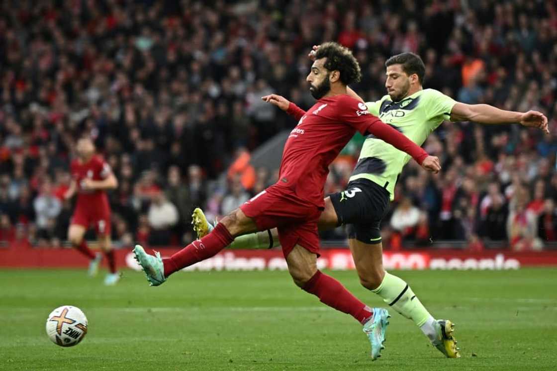 Liverpool match-winner Mohamed Salah (L) is challenged by Manchester City defender Ruben Dias. Liverpool match-winner Mohamed Salah (L) is challenged by Manchester City defender Ruben Dias.