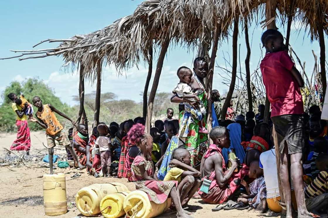 Women from Kenya's pastoral Turkana community wait on October 18, 2022 at a drought intervention community outreach clinic organised by UNICEF