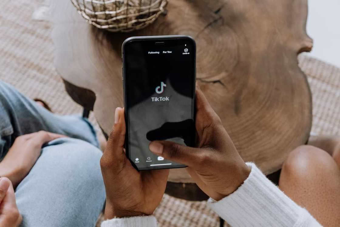 A person opening the TikTok app on their phone A person opening the TikTok app on their phone
