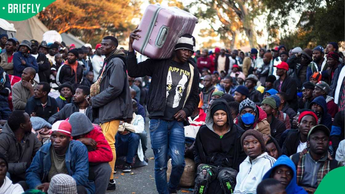 Malawian nationals wait to board buses outside the Malawian Consulate General in Johannesburg, South Africa Malawian nationals wait to board buses outside the Malawian Consulate General in Johannesburg, South Africa