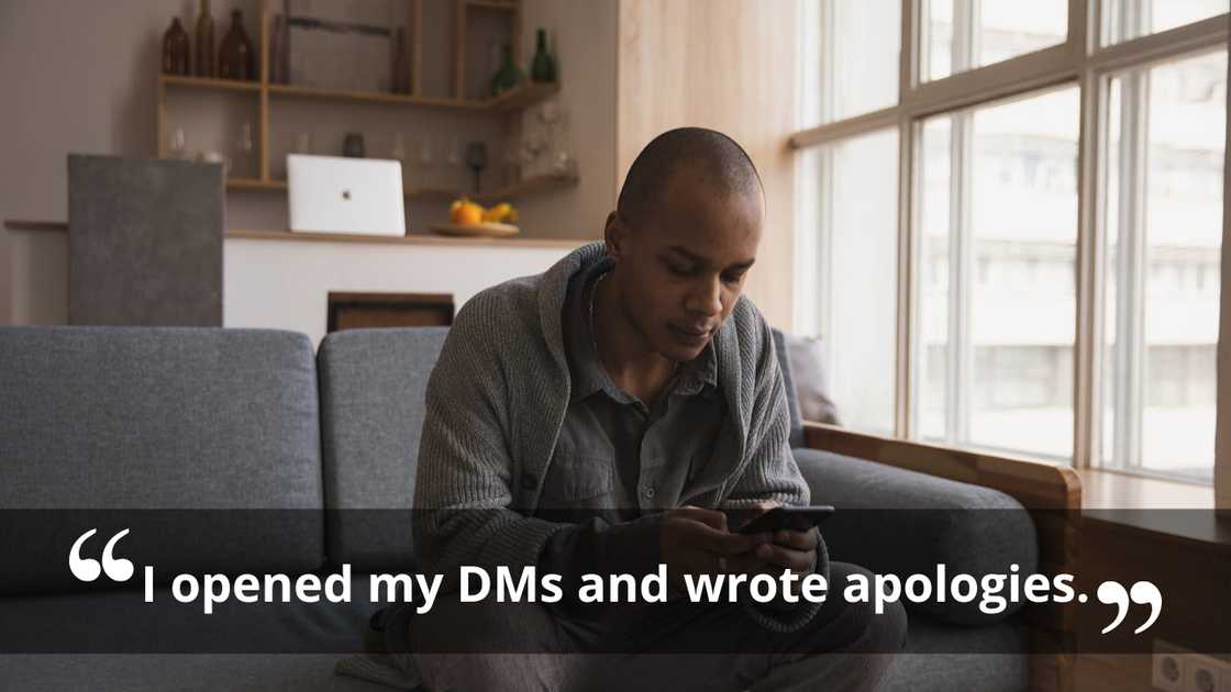 A man looking down at his phone with a serious expression.