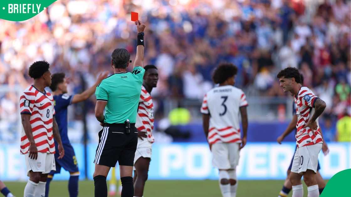 Referee Raphael Claus shows Folarin Balogun a red card for a foul on Tarik Muharemovic