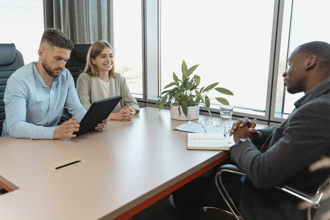 A young man sits during a job interview.
