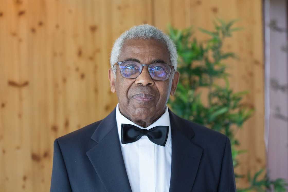 Elderly man in tuxedo and bow tie.
