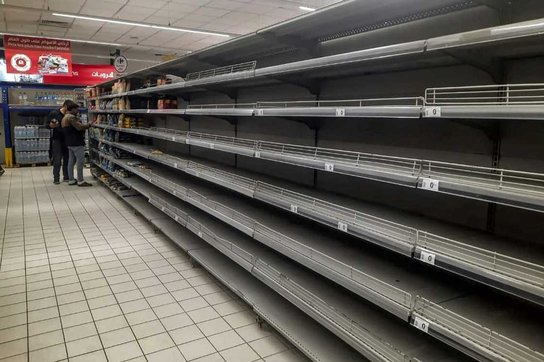 Empty shelves in a supermarket alley amidst a shortage of basic products in Tunisia's capital Tunis