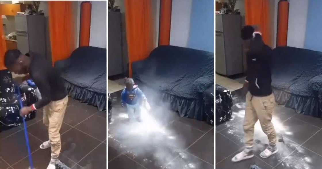 Man sweeping floor is disrupted by his kid. Man sweeping floor is disrupted by his kid.