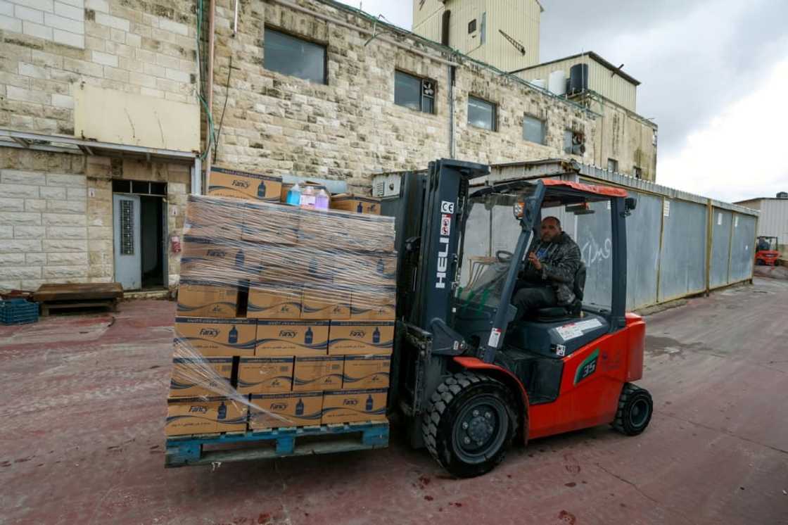 An employee transports boxes at Bishara Jubran's household products and cosmetics factory in the occupied West Bank city of Ramallah, who was able to keep his factory afloat by selling washing powder and other household products An employee transports boxes at Bishara Jubran's household products and cosmetics factory in the occupied West Bank city of Ramallah, who was able to keep his factory afloat by selling washing powder and other household products