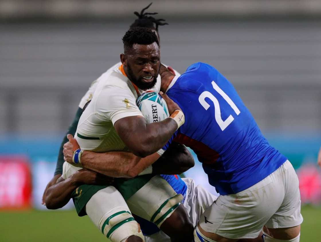 Siya Kolisi being tackled by Namibia's rugby players in a match Siya Kolisi being tackled by Namibia's rugby players in a match