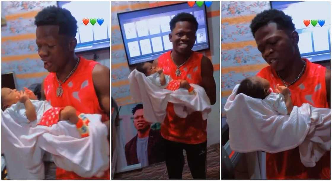 Nigerian man dances while holding his newborn baby. Nigerian man dances while holding his newborn baby.