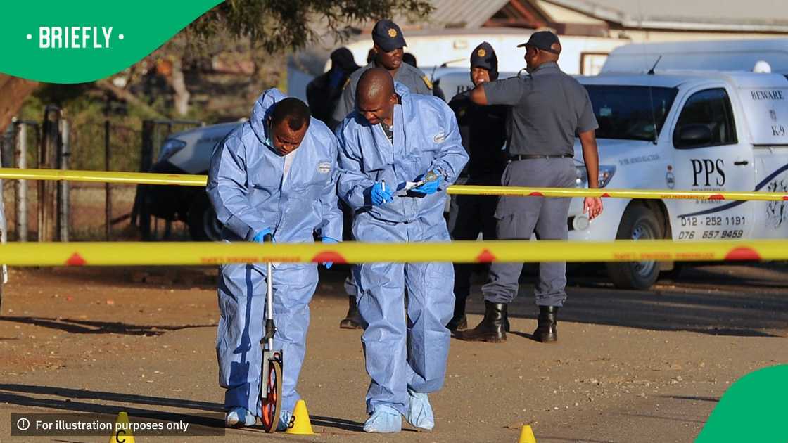 South African crime scene experts work at the scene of the shooting of a union leader who was killed inside the National Union of Mineworkers offices by two unknown gunmen, in Marikana on June 3, 2013
