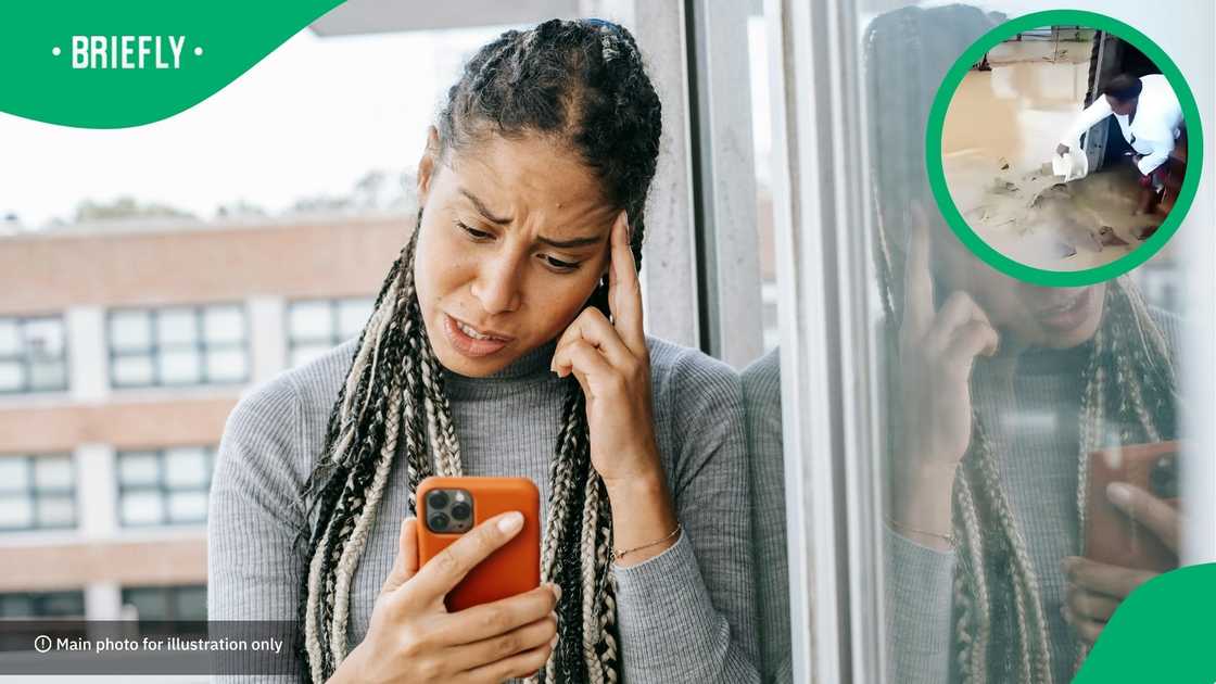 The woman was not the only person attempting to clear the water out, as other residents were also helping The woman was not the only person attempting to clear the water out, as other residents were also helping