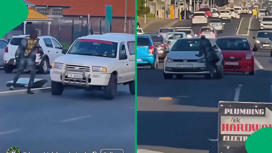 The individual stood in the middle of the road while a taxi approached at a slow speed