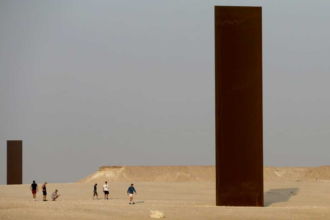 Two of the four steel slabs of US artist Richard Serra's "East-West/West-East" installation in the Qatari desert Two of the four steel slabs of US artist Richard Serra's "East-West/West-East" installation in the Qatari desert