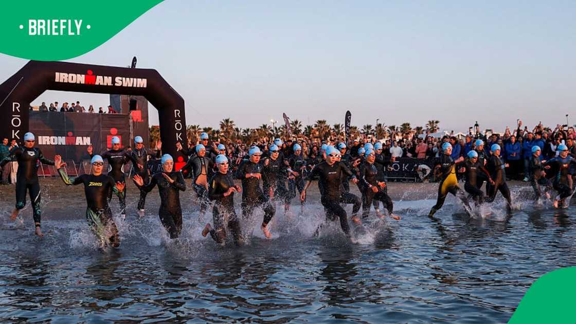 Ironman triathletes getting into the water.