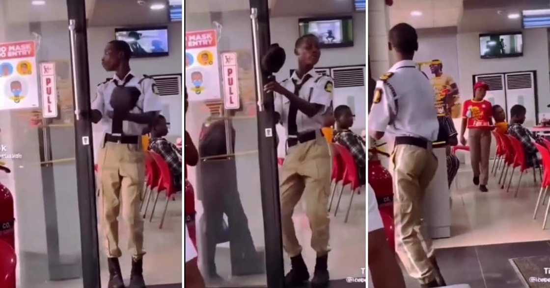 A security guard danced while opening a door. A security guard danced while opening a door.