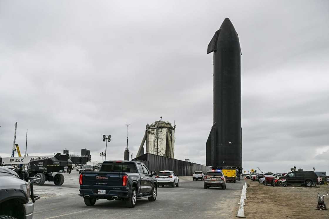 People gather as SpaceX Starship spacecraft prototype is transported from the launch site ahead of the SpaceX Starship third flight test from Starbase in Boca Chica, Texas