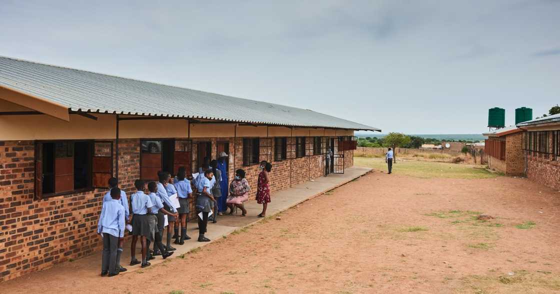 Students wait in line during a rural vaccination drive by BroadReach Group