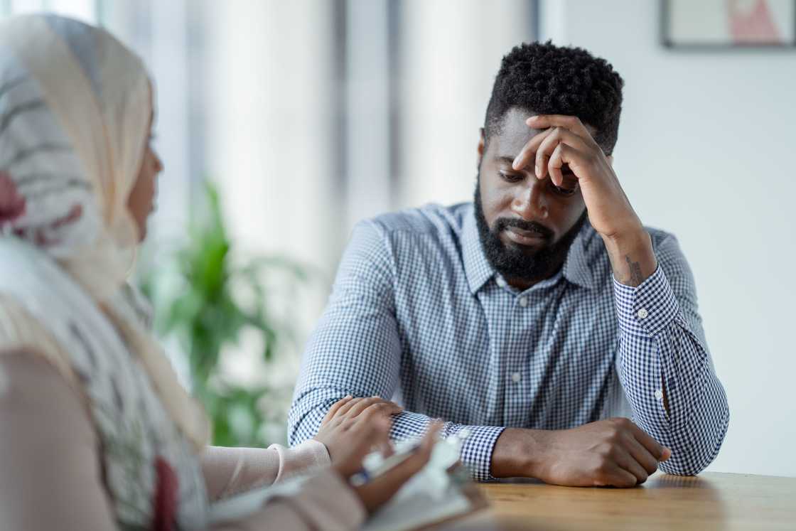 A man talks to his therapist during a counselling session.