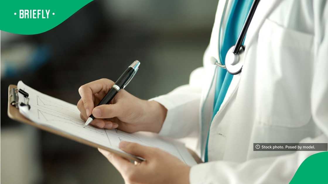 The professionally composed image showcased a doctor with a stethoscope draped around their neck writing patient notes during rounds