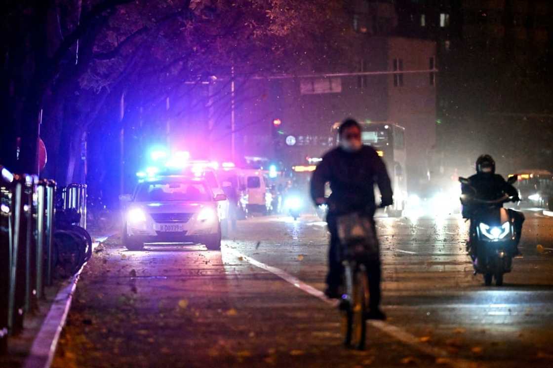 With police cars, patrols, a network of surveillance cameras, and aided by the icy wind, Beijing police appeared Monday to have deterred fresh anti-lockdown gatherings