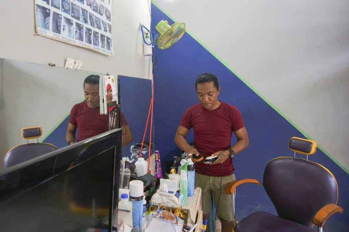 Kimtse Kimo Castello cleans his equipment at his small barber shop in Port Kaituma, Guyana Kimtse Kimo Castello cleans his equipment at his small barber shop in Port Kaituma, Guyana