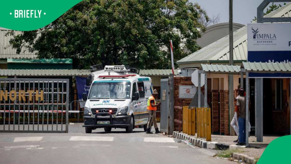 A security guard opens the gate for an emergency vehicle exiting the north shaft of Bafokeng Rasimone Platinum Mine near Rustenburg on December 19, 2023