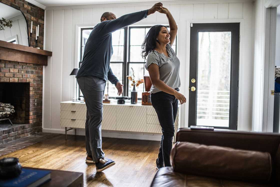 A couple dancing in their house. A couple dancing in their house.