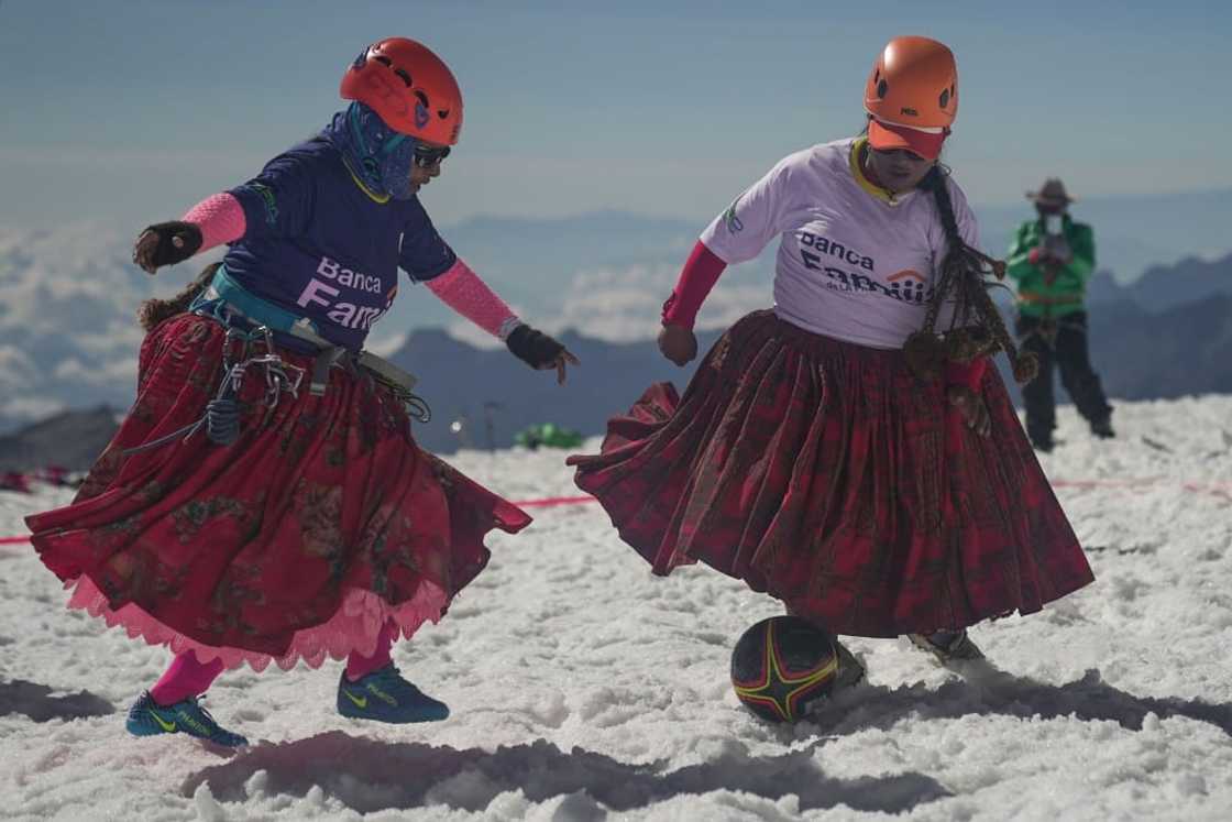 Cecilia Llusco (left) and Senobia Llusco vie for the ball in a high altitude football match after climbing the imposing 6.088-metre Huayna Potosi mountain Cecilia Llusco (left) and Senobia Llusco vie for the ball in a high altitude football match after climbing the imposing 6.088-metre Huayna Potosi mountain