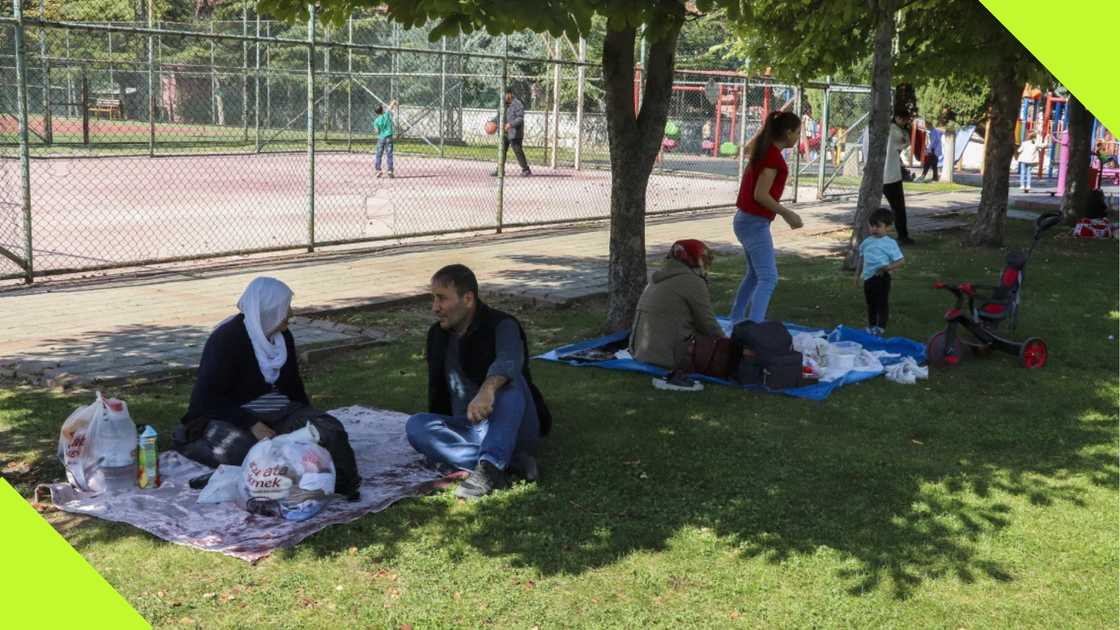 People rest in a public park outdoors away from buildings following an earthquake in Malatya, southern Turkey, Wednesday, Oct. 16, 2024.