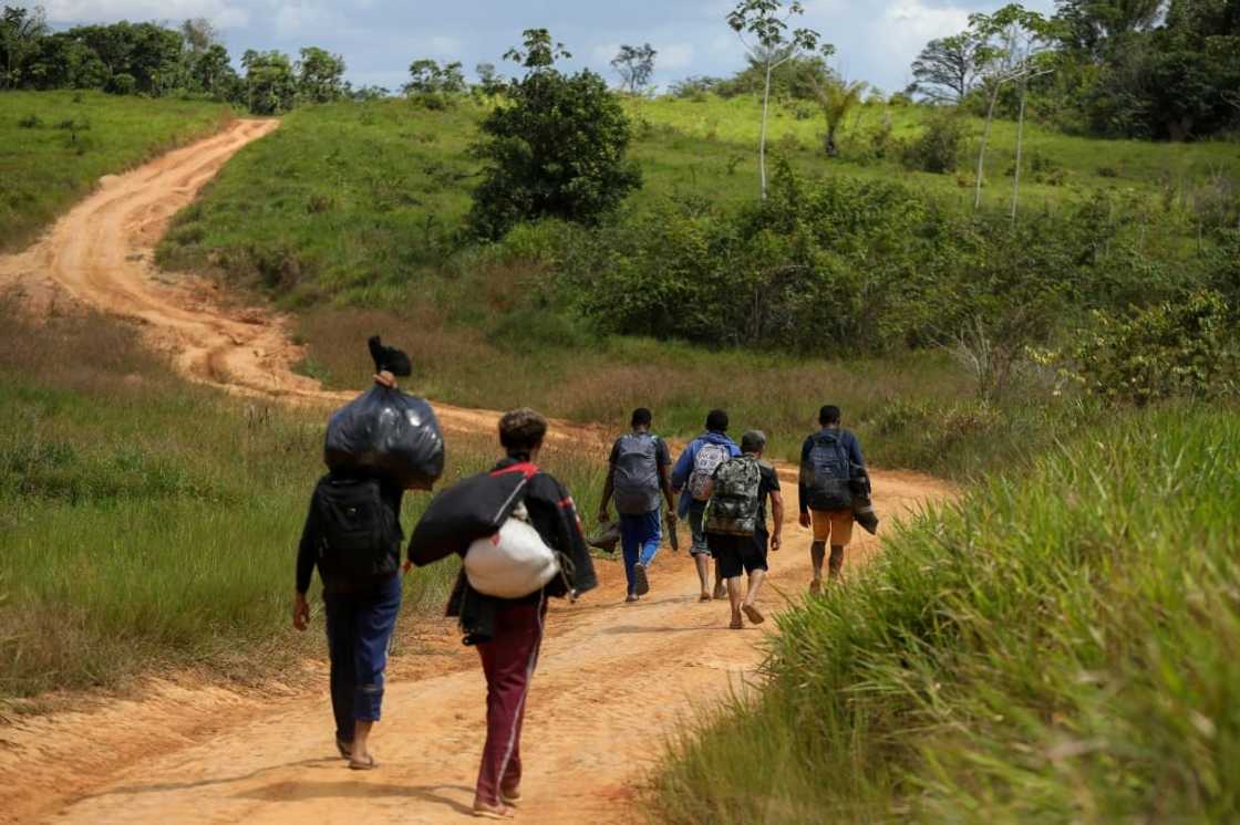Alleged illegal miners leave a mining area inside Yanomami Indigenous land in northwestern Brazil Alleged illegal miners leave a mining area inside Yanomami Indigenous land in northwestern Brazil