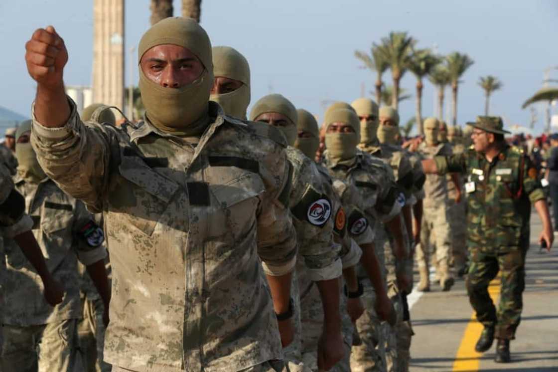 Masked Libyan soldiers take part in a military parade in the capital Tripoli on August 9