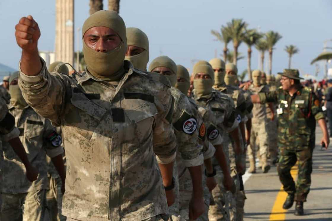 Masked Libyan soldiers take part in a military parade in the capital Tripoli on August 9 Masked Libyan soldiers take part in a military parade in the capital Tripoli on August 9