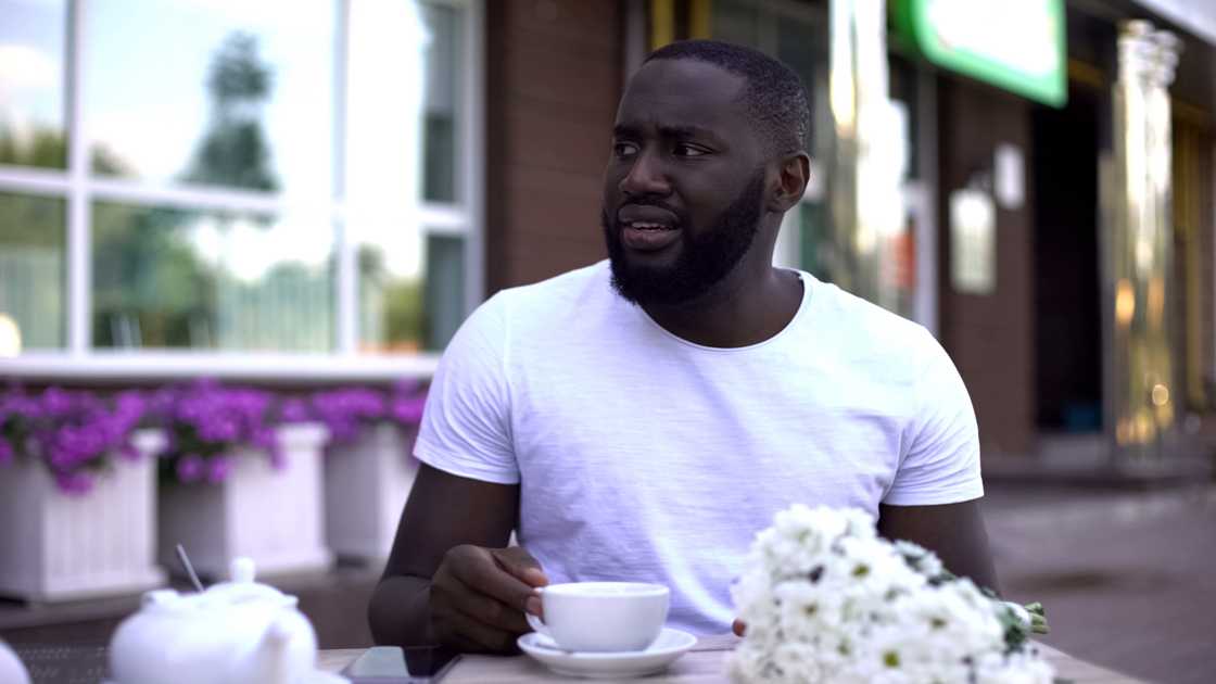A man taking tea outside A man taking tea outside