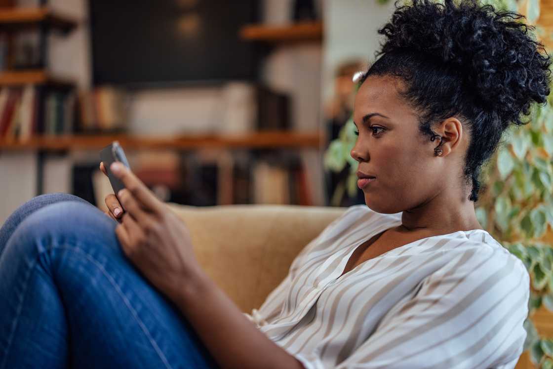 A curious woman checking her phone