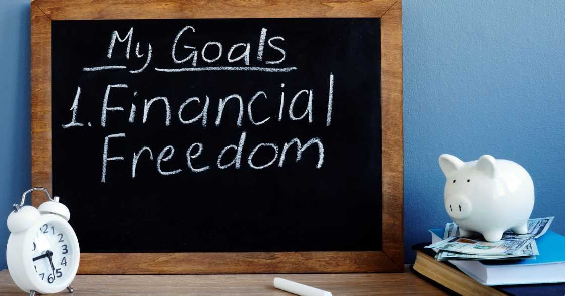 My goals and financial freedom written on a blackboard. My goals and financial freedom written on a blackboard.