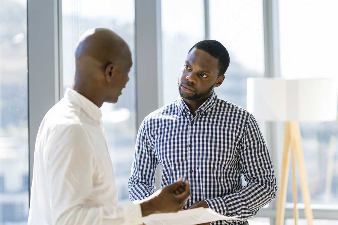 Businessmen discussing in office Businessmen discussing in office
