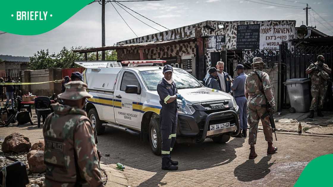 Members of South Africa's Forensic Pathology Service and South African National Defence Force (SANDF) inspect and secure the scene where gunmen armed with assault rifles stormed a bar in Johannesburg on September 27, 2026