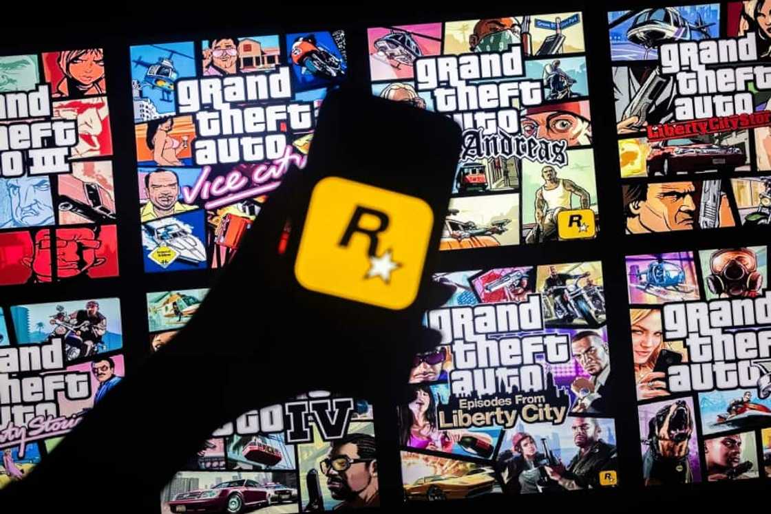 This illusttation shows a logo of Rockstar Games on a smartphone screen and covers of video game series Grand Theft Auto (GTA) on a TV screen in New York, November 27, 2023 This illusttation shows a logo of Rockstar Games on a smartphone screen and covers of video game series Grand Theft Auto (GTA) on a TV screen in New York, November 27, 2023
