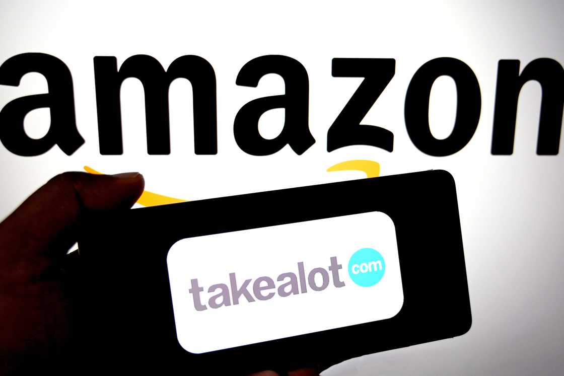 In this photo illustration, a Takealot logo is seen displayed on a smartphone with an Amazon logo in the background. In this photo illustration, a Takealot logo is seen displayed on a smartphone with an Amazon logo in the background.